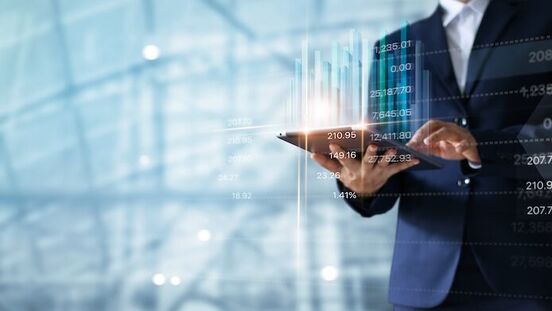 Businessman,Using,Tablet,Analyzing,Sales,Data,And,Economic,Growth,Graph