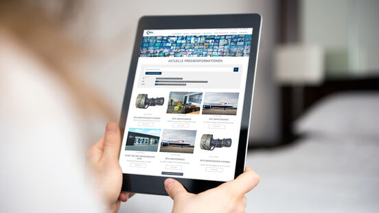 Young woman looking at a modern digital tablet computer screen. There is an internet web page visable on the monitor of the digital device.